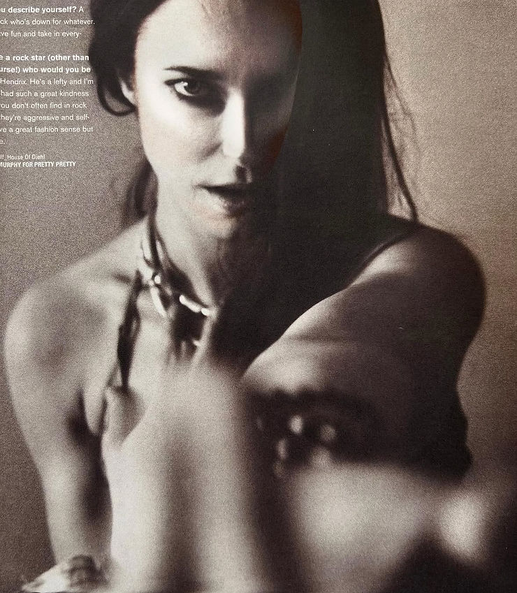 Black and white image of a woman looking intensely at the camera.
