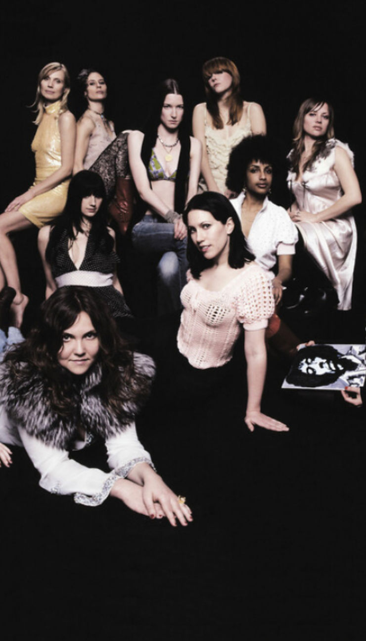 Eight women pose on a dark background, wearing various stylish outfits.