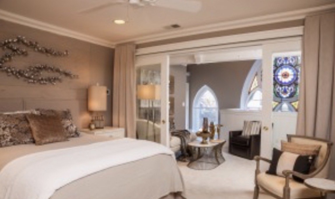 Showhouse foyer with white and brass chairs, a parquet floor and a white chest